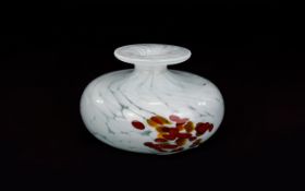 A Studio Art Glass Squat Bud Vase Small vase in white confetti glass with organic ochre and orange