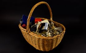 A Basket Containing A Large Quantity Of Mixed Costume Jewellery Wicker basket with a varied