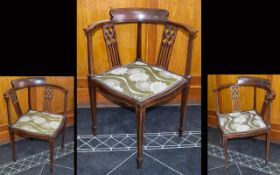 An Edwardian Walnut Corner Chair with string and cross banding and ornate splats to back rest.