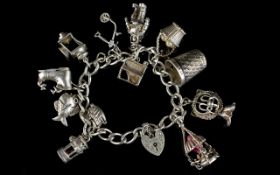 Silver Curb Bracelet Loaded with 12 Good Quality Silver Charms. All Marked for Silver. c.