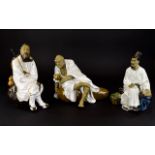 Three Oriental Figures A trio of earthenware figures each finished in white glaze, all in good