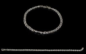 A 9ct White Gold Curb And Twist Bracelet Delicate bracelet fashioned in white gold with twisted and