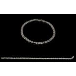 A 9ct White Gold Curb And Twist Bracelet Delicate bracelet fashioned in white gold with twisted and