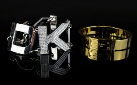 Two Designer Bracelets comprising statement DKNY Bracelet and Michael Kors gold toned bangle.