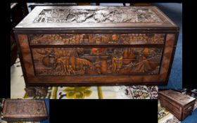 A Carved Camphor Chest And Associated Coffee Table Profusely carved,