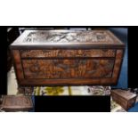 A Carved Camphor Chest And Associated Coffee Table Profusely carved,