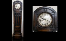 A Westminster Chime Granddaughter Clock Oak Cased With Silvered Dial And Arabic Numerals.