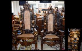 A Pair Of Large Ornately Carved Throne Chairs 20th century high backed chairs with heavily carved