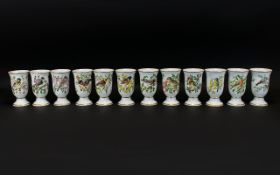 A Set of 12 Japanese Ceramic Goblets, 'Oiseaux Chanteurs De L'Europe,