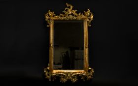 A Bevelled Glass Gilt Framed Mirror Rectangular ornate rococo style mirror with yellow gilt frame