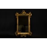 A Bevelled Glass Gilt Framed Mirror Rectangular ornate rococo style mirror with yellow gilt frame