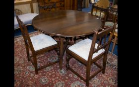 Dark Wood Drop Leaf Dining Table Of plain form with x-frame bottom stretcher.