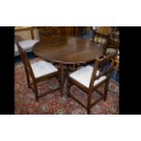 Dark Wood Drop Leaf Dining Table Of plain form with x-frame bottom stretcher.