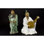 A Pair Of Oriental Figures The first fashioned in resin in the form of a seated Mandolin player