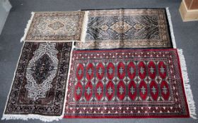 A Collection Of Four Indian Carpets Four woven carpets each in traditional Anglo Indian and Persian