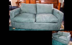 Contemporary Two Seater Sofa Bed A plush upholstered sofa bed in moss green moleskin fabric with bun