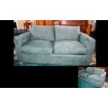 Contemporary Two Seater Sofa Bed A plush upholstered sofa bed in moss green moleskin fabric with bun