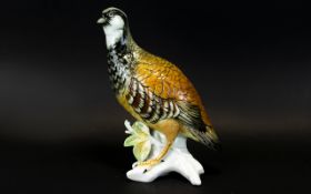 A Czech Ceramic Figure In The Form Of A Grouse Detailed figure on stylised branches, glazed finish,