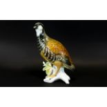 A Czech Ceramic Figure In The Form Of A Grouse Detailed figure on stylised branches, glazed finish,