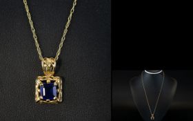 A Contemporary 9ct Gold Open worked Mounted Sapphire Set Pendant Drop with Attached 9ct Gold Chain.