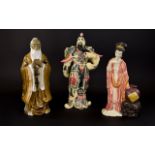 Three Decorative Oriental Figures The first, a resin figure in the form of a Japanese emperor with