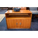 A 1970's Low Sideboard By Gibbs Teak bookshelf/sideboard of plain form with double doors to