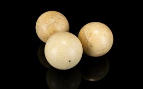 Antique Ivory Bowling Balls Three small spherical pentanque balls with aged patina