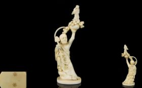 Japanese Small Early 20th Century Carved Ivory Mythical Figure of a Priest Like Man Holding Above