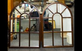 A Pair Of Large Contemporary Mirrors Two arched astral glazed bevelled glass mirrors in dark wood