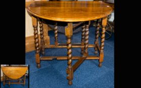 Antique Oak Dropleaf Table Large oak table of plain form with barley twist legs, aged patina.