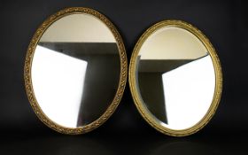 Two Oval Mirrors Decorative mirrors each with ornate oval gilt frames, 22 x 20 inches.