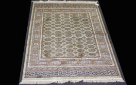 A Large Woven Silk Bokhara Carpet Ornate silk carpet with traditional lozenge and geometric repeat