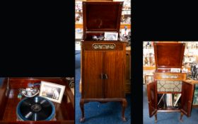 Antique Gramophone Large mahogany cabinet with hinged top section above two cupboard doors,