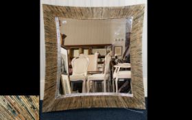 A Large Decorative Mirror Concave mirror with unusual rolled newsprint papier mache frame.