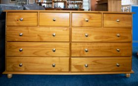 Pine Effect Side Cabinet Four frieze drawers above six long drawers. Marked Julian Bowen Products.