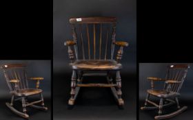 Antique Child's Rocking Chair Miniature rocking chair with turned spindles and aged patina.