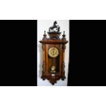 A Vienna Spring Driven Wall Clock walnut case, glazed front and side with pendulum.