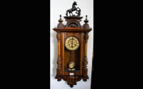 A Vienna Spring Driven Wall Clock walnut case, glazed front and side with pendulum.