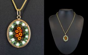 Millefiori Pendant and Chain Oval pendant on matte gold tone chain, the pendant in tones of red,