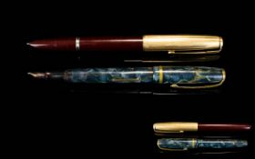 Two Vintage Pens The first a 1940's Parker with gilt top and branded clip, the body of claret resin.