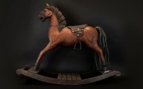 A Vintage Rocking Horse Miniature carved wooden horse on rockers with tooled leather saddle and