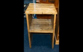 A Rustic Pine Bedside Table Of square form with slatted top and central storage section.