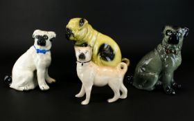 A Collection Of Antique Ceramic Pug Figurines Four in total to include 19th century Staffordshire