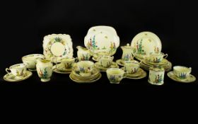 A Crown Staffordshire Part Tea Service on a white background with blue, yellow and pink flowers,