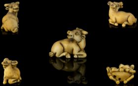 Japanese Early 19th Century Nice Quality And Signed Carved Ivory Netsuke in the form of a horned