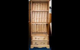 A Solid Pitched Pine Bookcase Medium sized bookcase with three shelves above two drawers.
