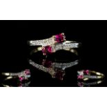 Ladies 9ct Gold Twin Snake Eyed Ruby And Diamond Set Dress Ring. Fully hallmarked for 9ct Gold.