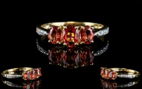 9ct Gold Diamond and Fire Opal Three Stone Dress Ring the three fine ovals of excellent colour,