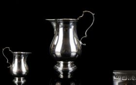 Elizabeth II Helmet Shaped Solid Silver Cream Jug with ornate scroll handle of good form and solid