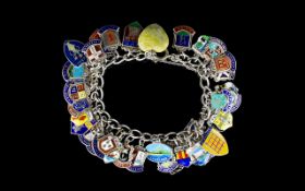 A Vintage Silver Curb Bracelet Loaded with enamel on silver shield medallions of town crests,